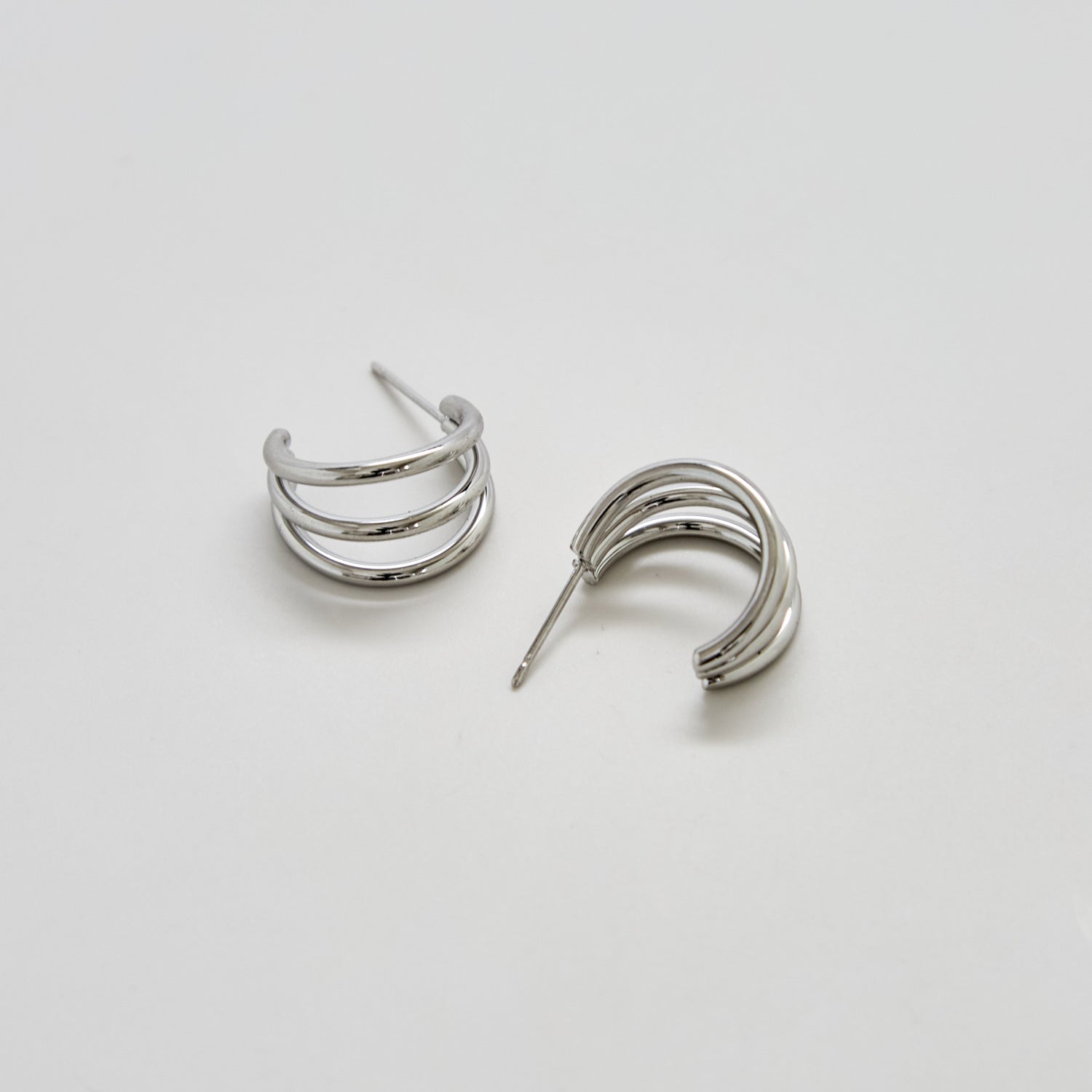 Pair of silver hoop earrings on a light gray background