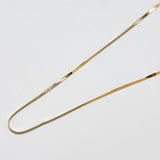 Close-up of vintage gold herringbone chain necklace showing flat, reflective links and polished finish.