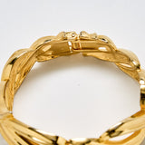 Close-up of vintage gold sculptural link bracelet showing hinged clasp mechanism