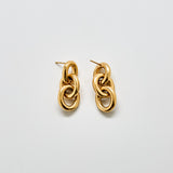 Angled view of vintage Monet gold chain link earrings showing dimensional link design and post back closure.