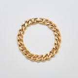Full view of vintage Monet gold-tone chain bracelet featuring bold curb-style links and fold-over clasp.