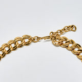Detail of vintage Monet necklace clasp and extender chain in polished gold-tone metal.