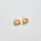 Front view of vintage Monet gold-tone open-heart stud earrings with sculptural design and polished finish.