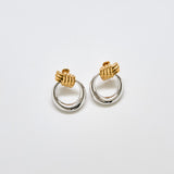 Pair of vintage Monet two-tone door knocker earrings with gold knot tops and silver-tone circular drops