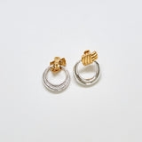 Back view of vintage Monet two-tone earrings showing clip-back closure and mixed metal finish.