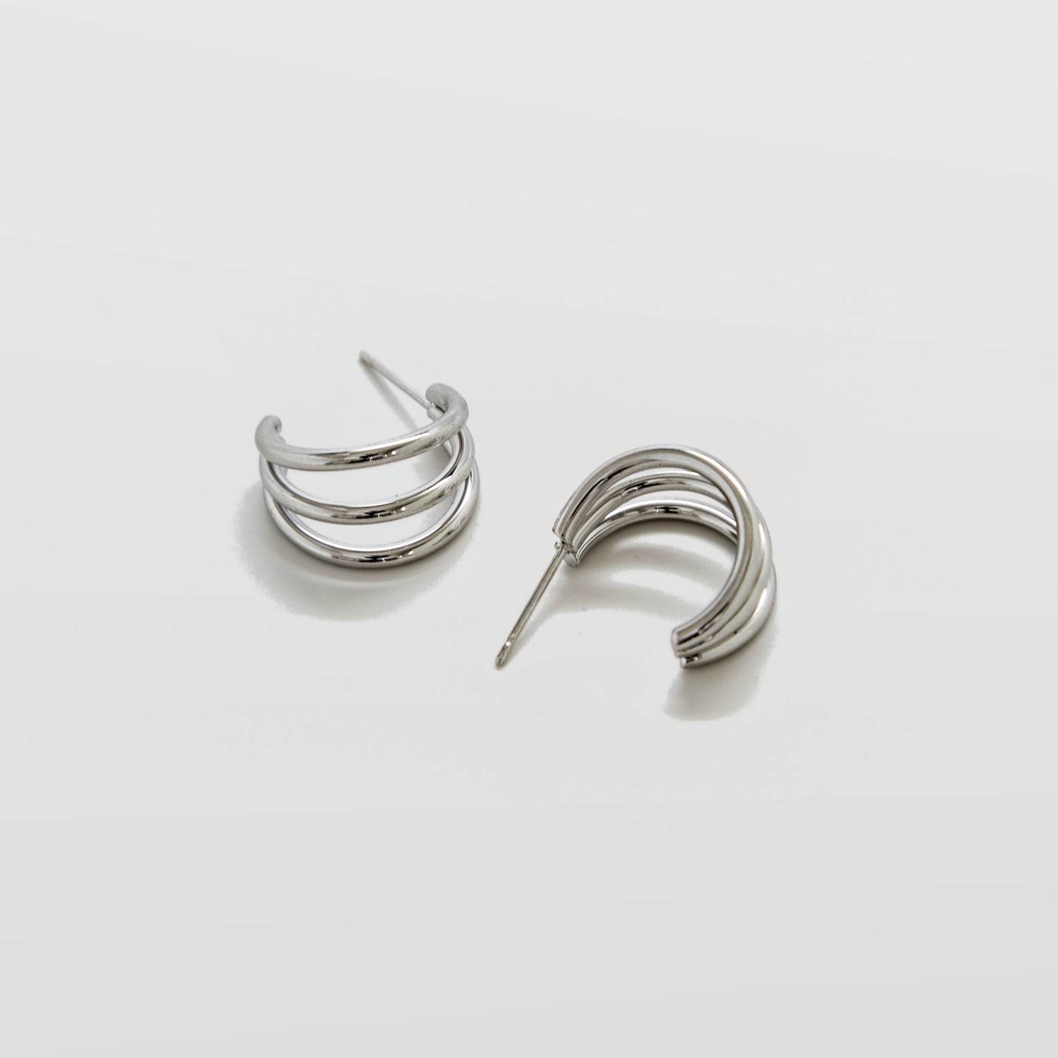 Pair of silver hoop earrings on a light gray background