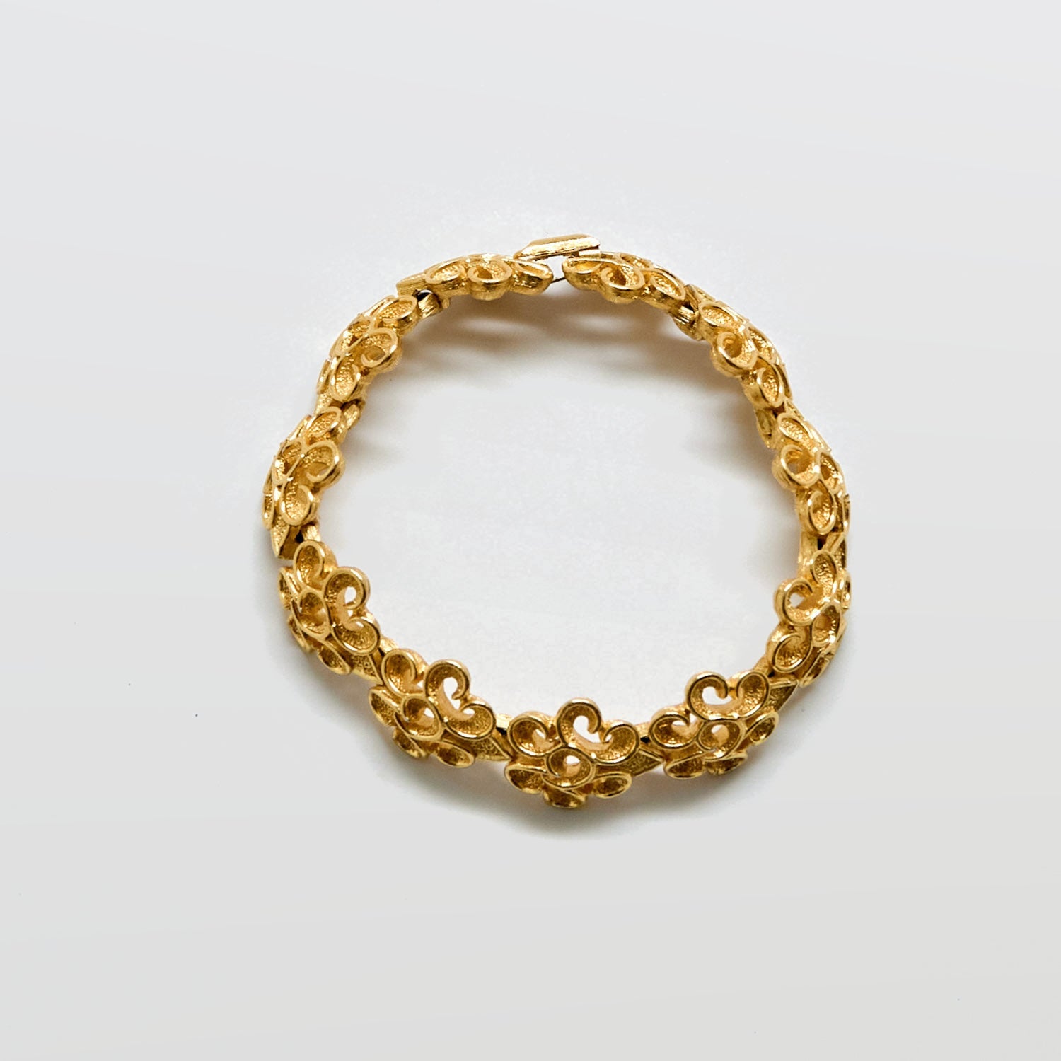 Gold bracelet on a white background