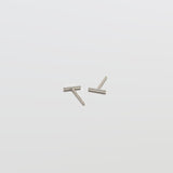 Two silver bar earrings on a white background
