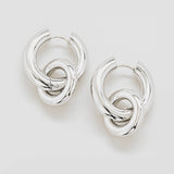 Pair of silver hoop earrings on a light gray background