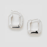 Pair of silver hoop earrings on a light gray background