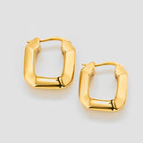 Gold hoop earrings on a light gray background