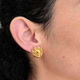 Model wearing Vintage Anne Klein gold-tone lion medallion clip-on earring, close-up
