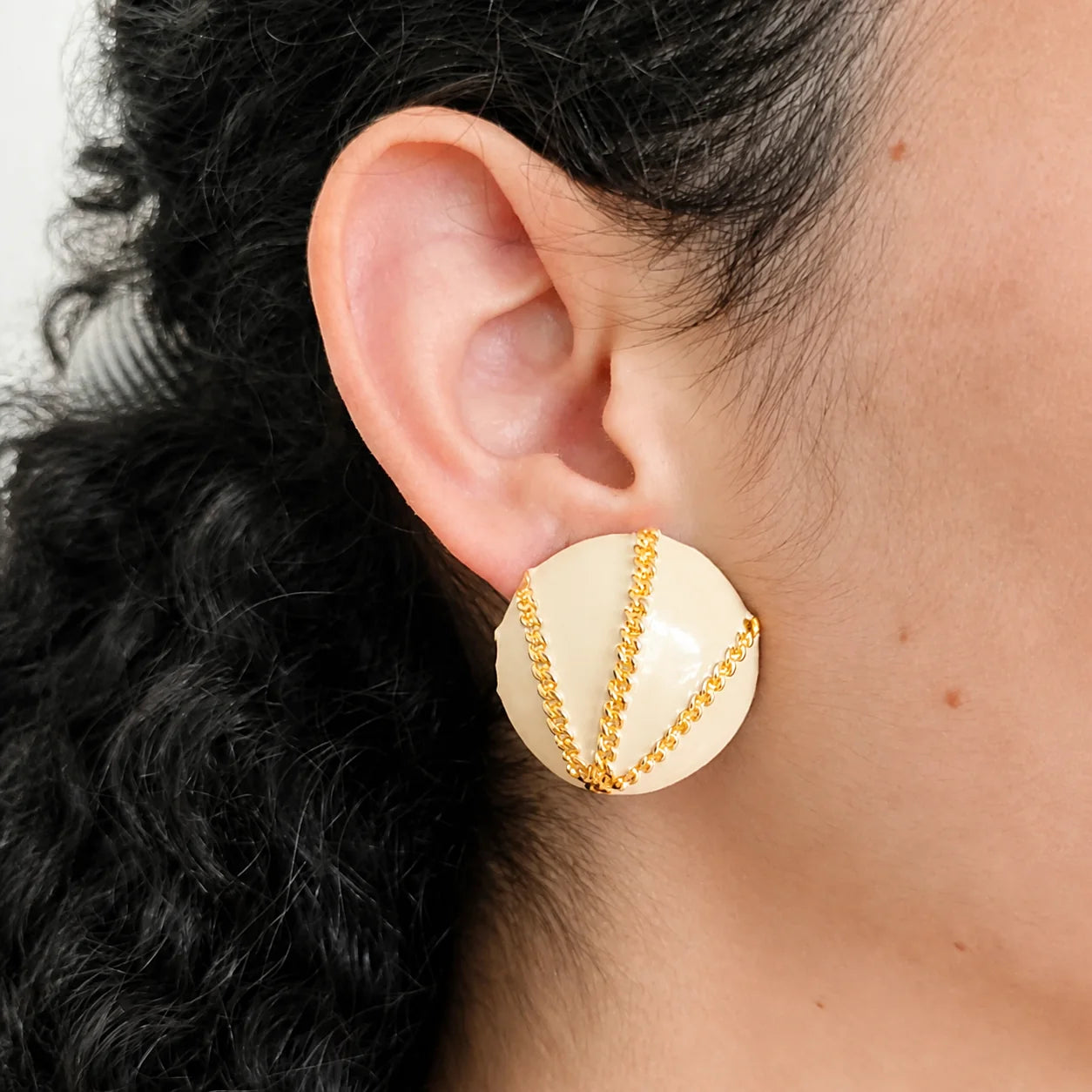 Model wearing Vintage ivory enamel and gold-tone chain clip-on earring, close-up