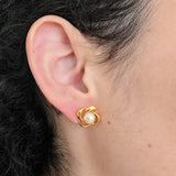 Model wearing Vintage faux pearl knot stud earring, close-up