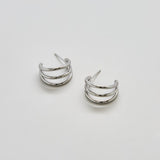 Pair of silver hoop earrings on a light gray background