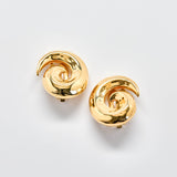 Pair of gold spiral earrings on a light gray background