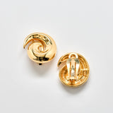 Pair of gold spiral earrings on a light gray background