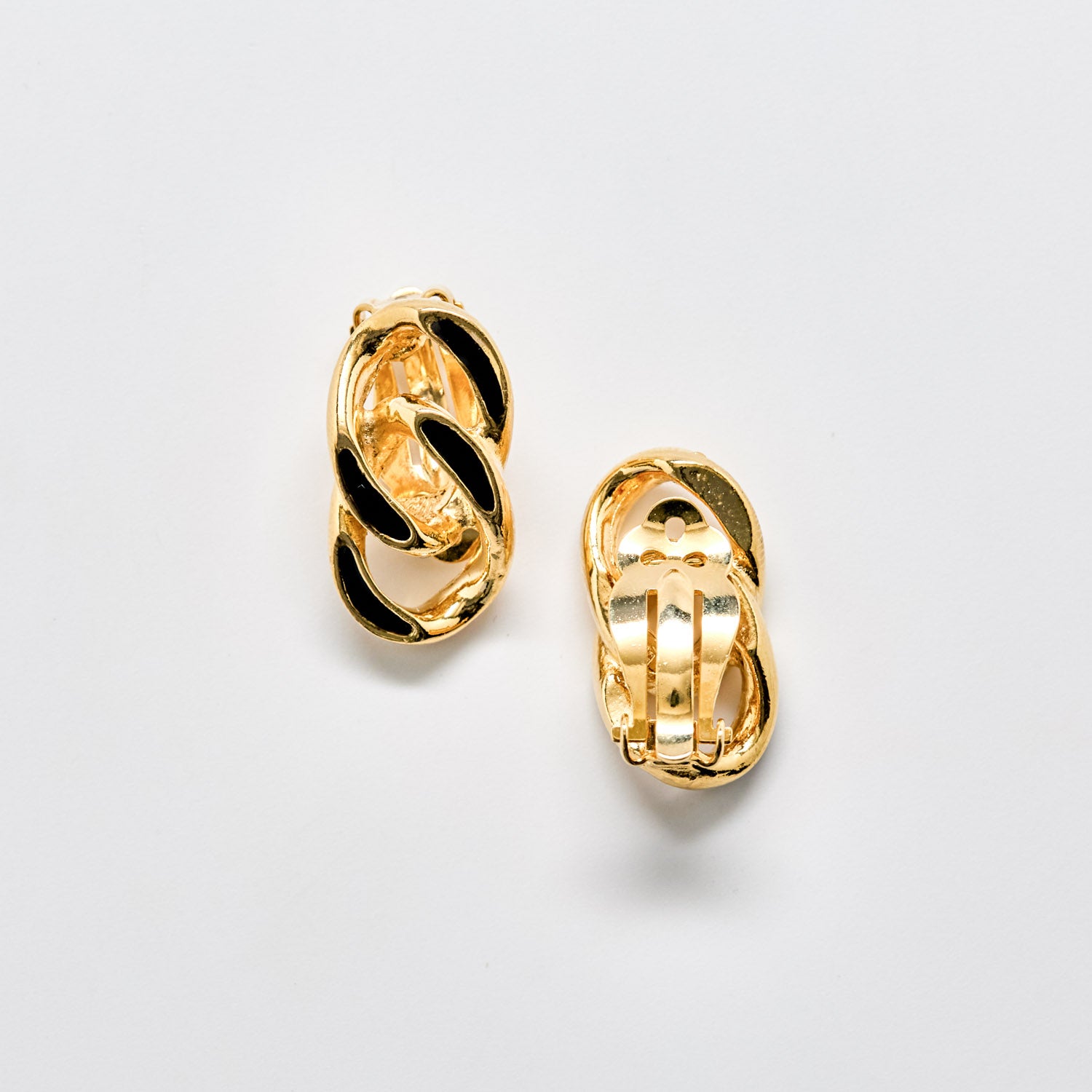 Pair of gold hoop earrings on a light gray background
