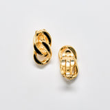 Pair of gold hoop earrings on a light gray background