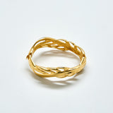 Gold bracelet on a light gray background