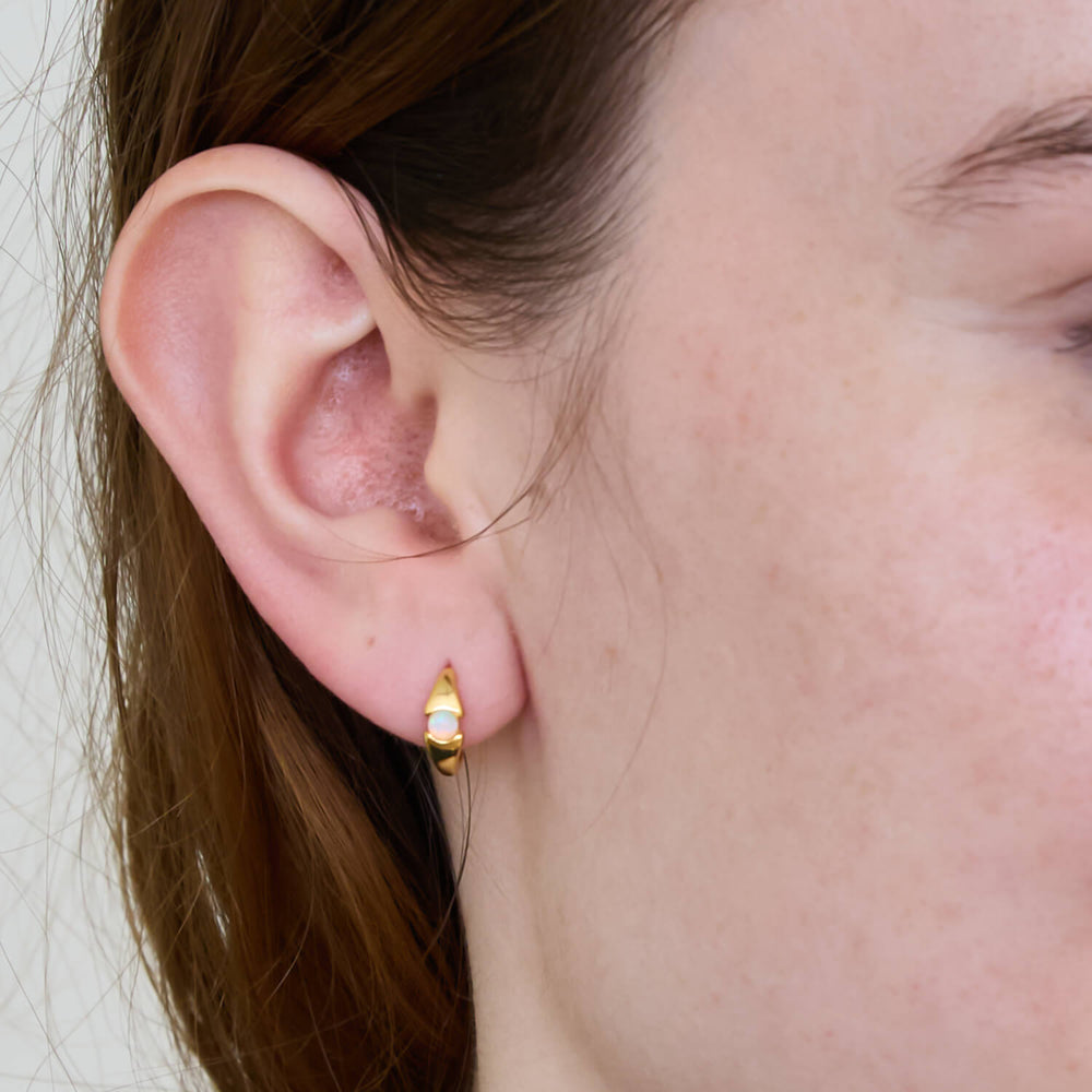 Gold Opal Mini Huggie Hoop Earring worn on a lobe