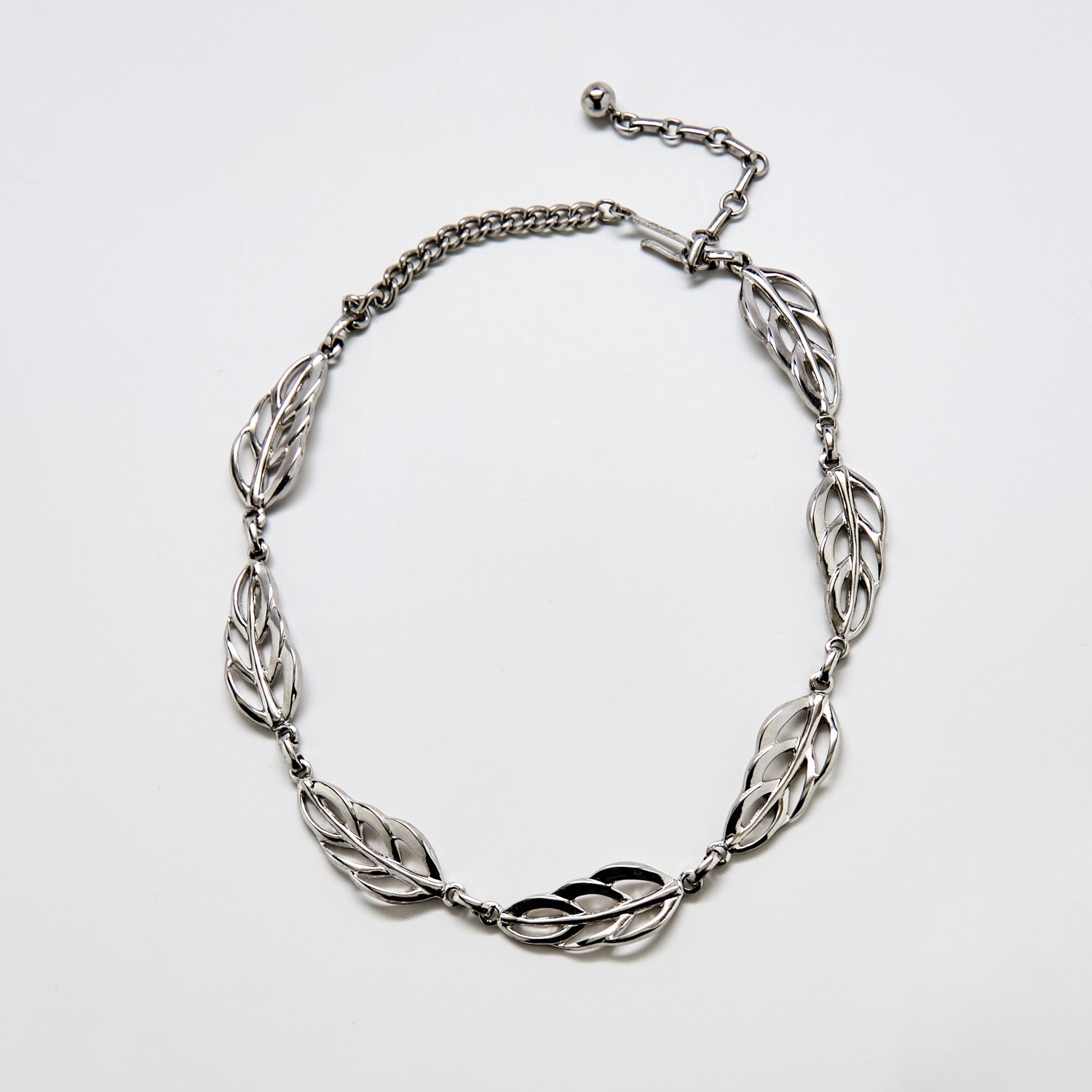 Full view of vintage Barclay silver-tone choker necklace featuring linked openwork leaf motifs and adjustable chain.