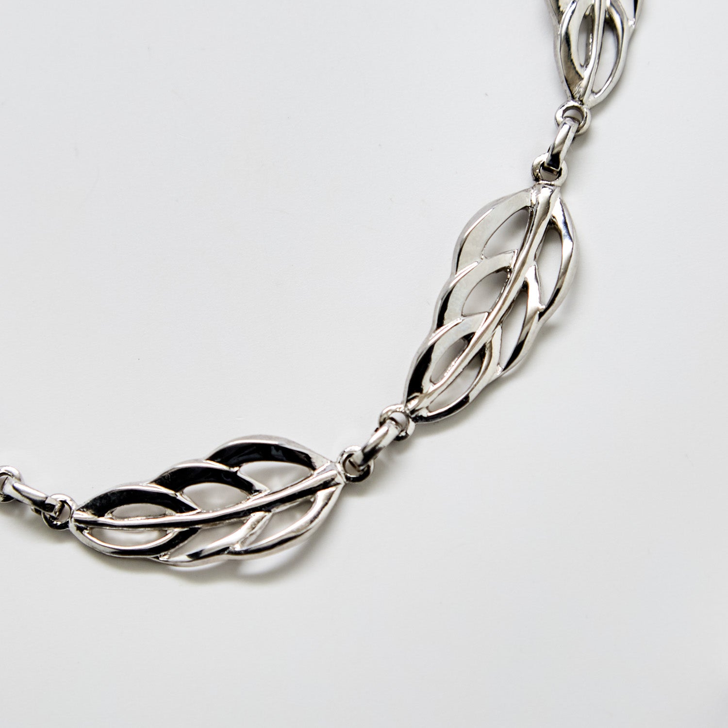 Close-up of vintage Barclay silver leaf necklace showing detailed openwork link design and polished silver finish.