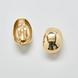 Back view of vintage gold dome earrings showing clip-on closure and smooth interior design.