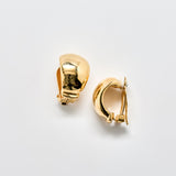 Gold hoop earrings on a light gray background