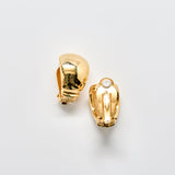 Gold hoop earrings on a light gray background