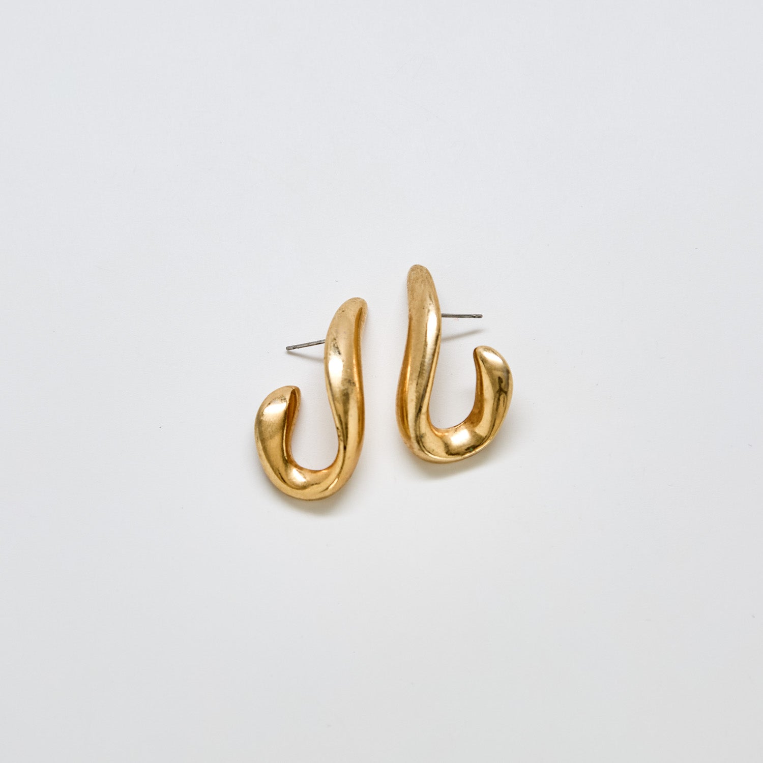Pair of vintage JS abstract sculptural earrings in gold-tone metal with modern curved design