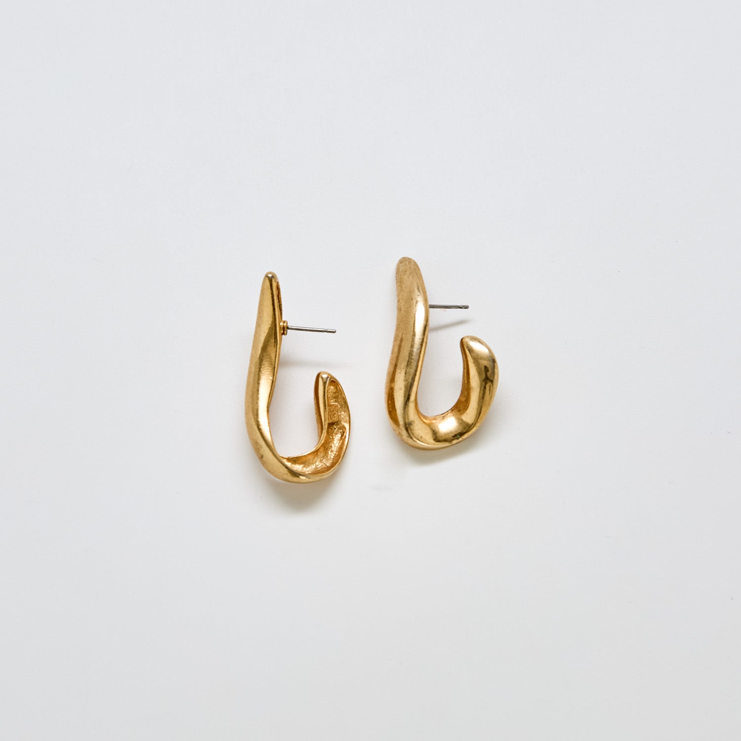 Pair of vintage JS abstract sculptural earrings in gold-tone metal with modern curved design
