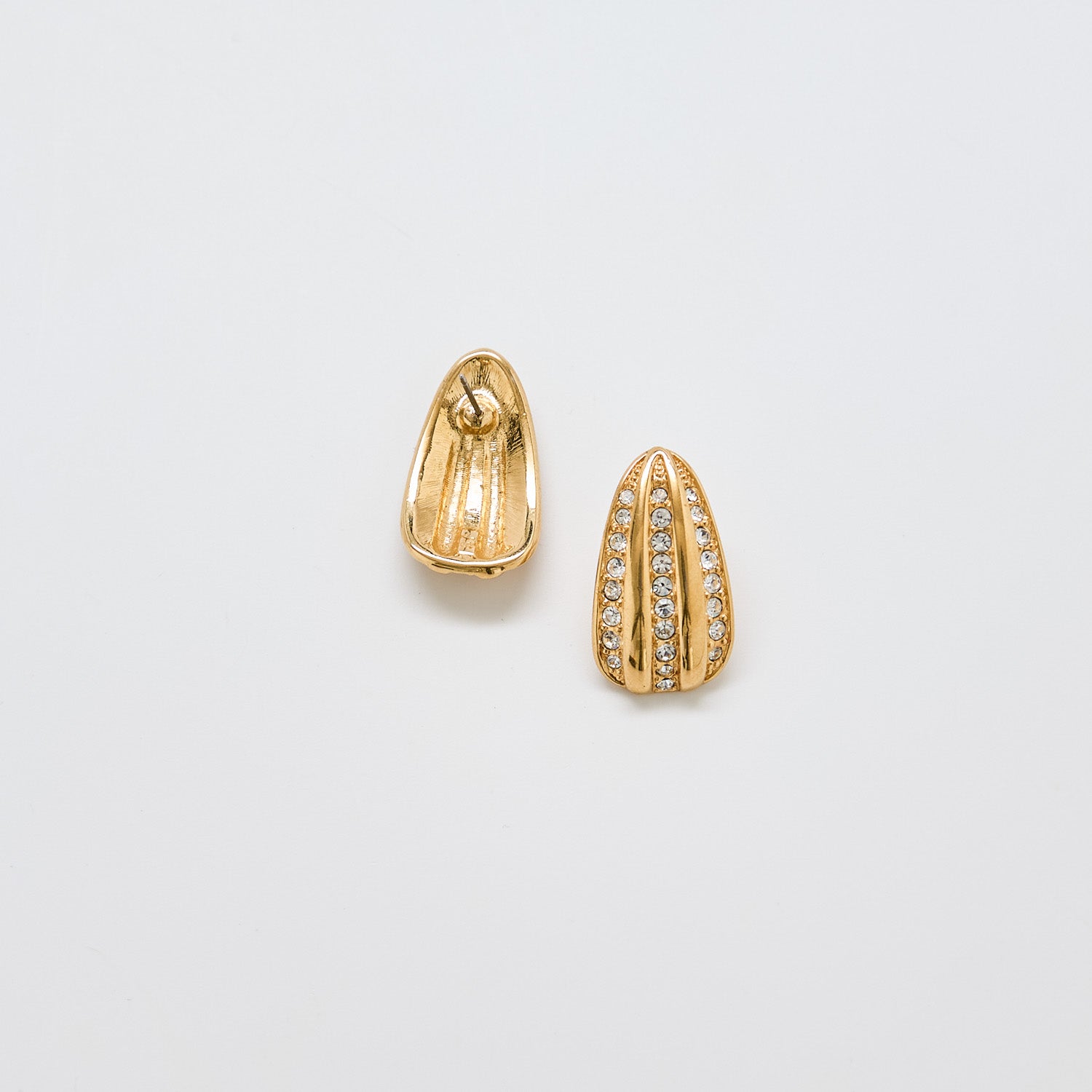 Back view of vintage JS rhinestone earrings showing gold-tone metal setting and post back closure.