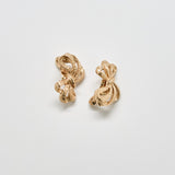 Pair of gold earrings on a light gray background