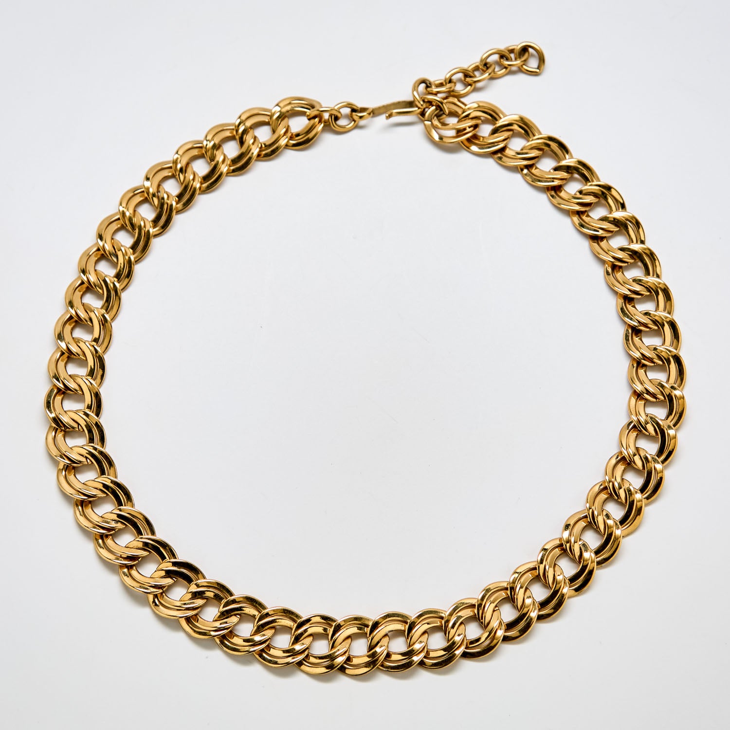 Full view of vintage Monet gold-tone double-link chain necklace with polished finish and adjustable clasp