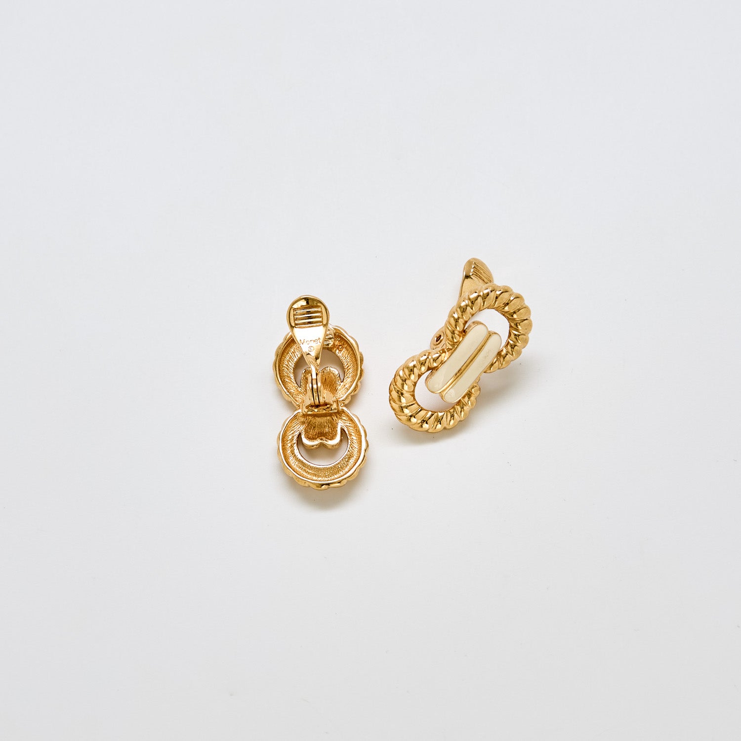 Back view of vintage Monet gold and ivory enamel link earrings showing clip-back closure and detailed finish
