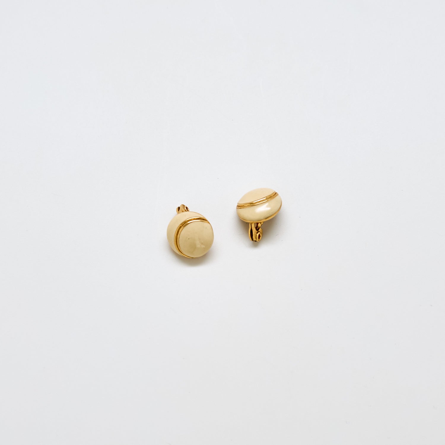 Pair of vintage Monet ivory enamel button earrings with gold-tone accent band