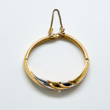 Gold and silver bracelet on a light gray background
