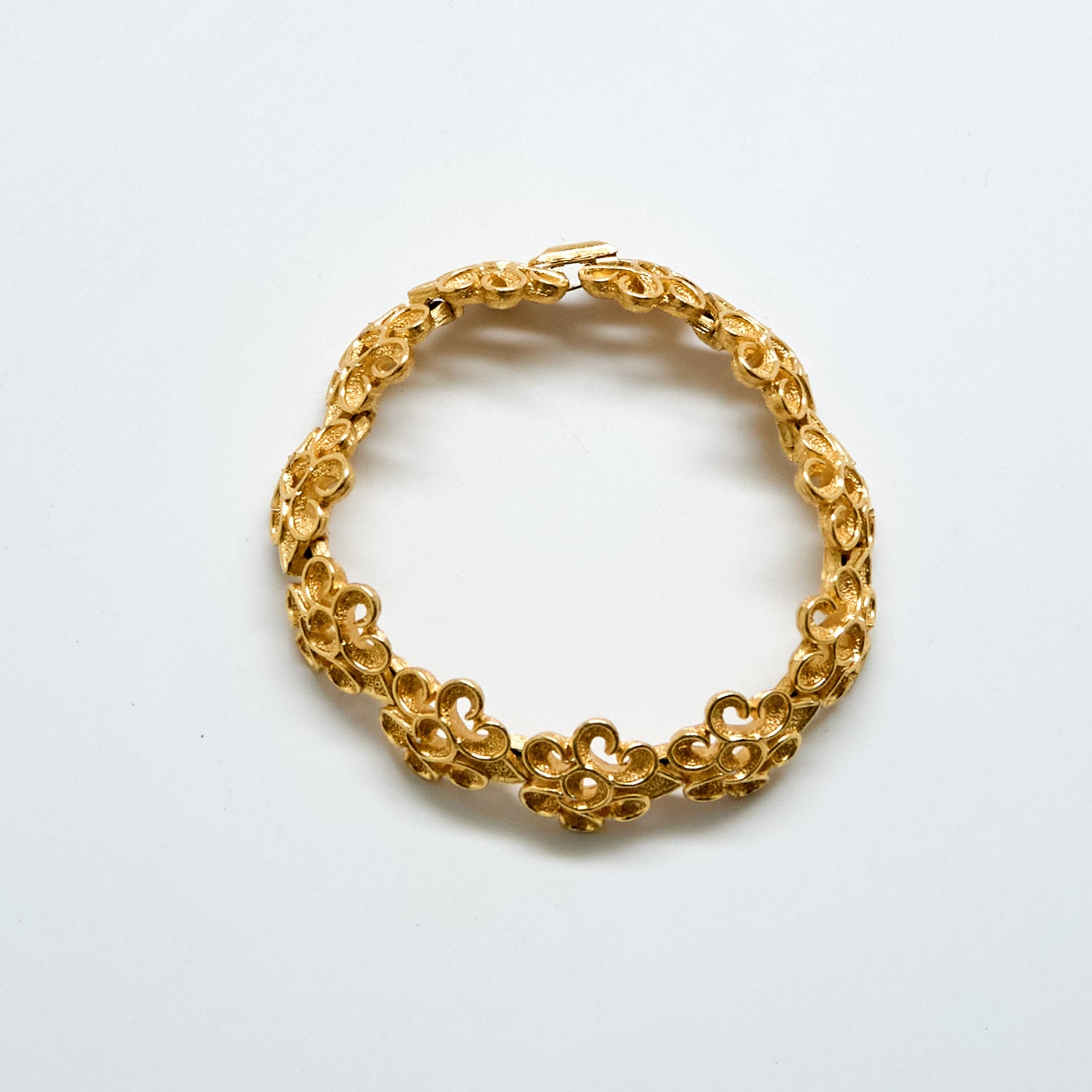 Gold bracelet on a white background