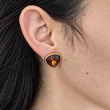 Vintage Swarovski amber-tone triangle stud earring — on-ear view