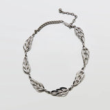 Vintage Barclay textured silver-tone leaf choker necklace on a light gray background