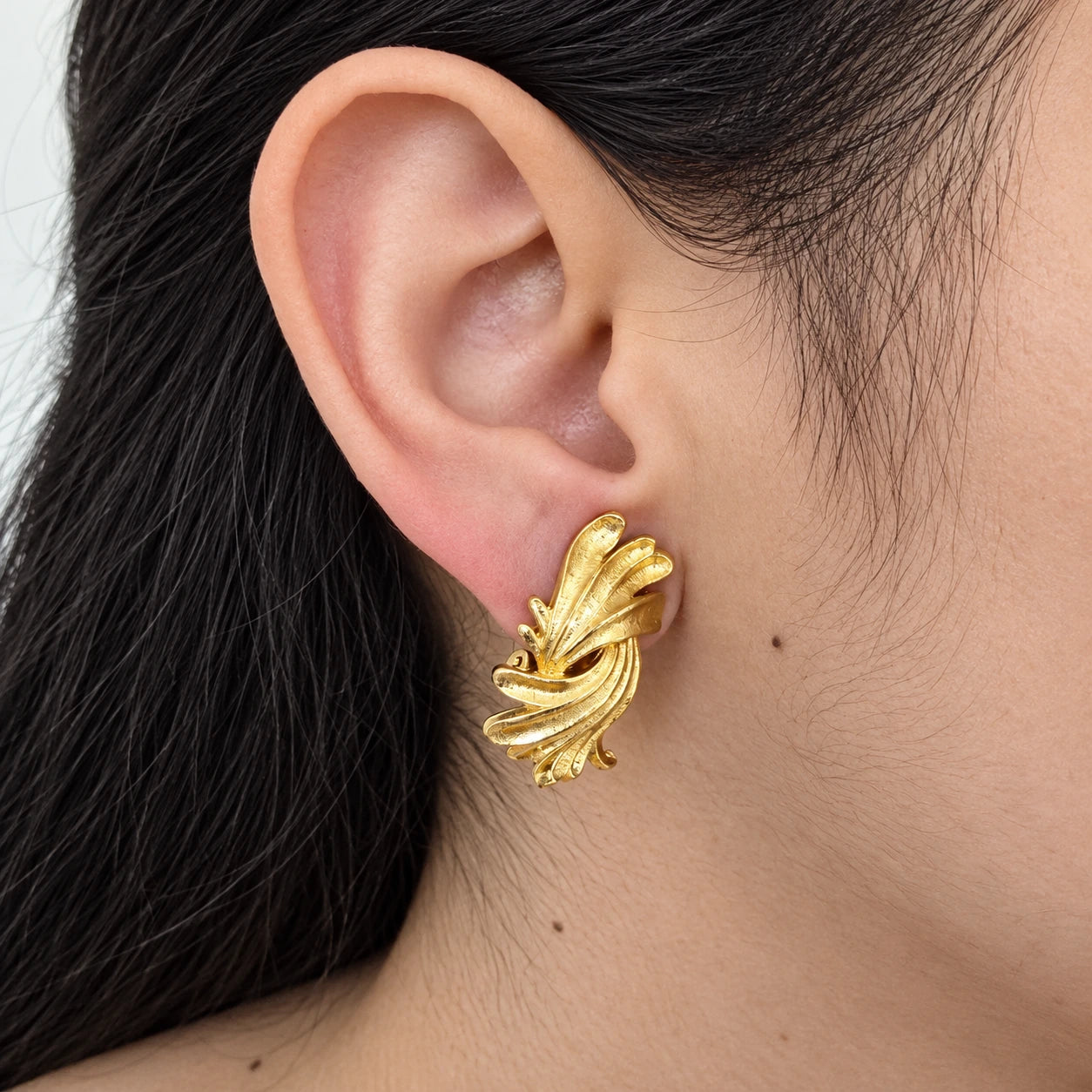 Vintage gold-tone fluted fan clip-on earrings — on-ear view
