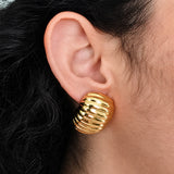 Vintage gold-tone ribbed clip-on earrings — modeled