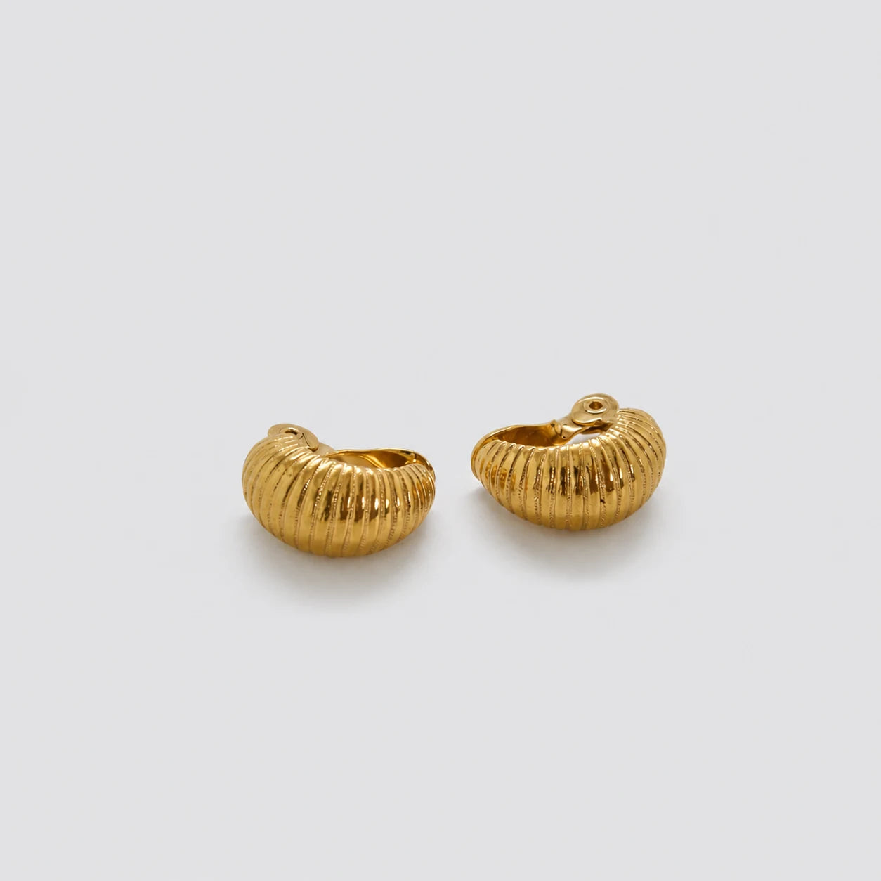 Vintage gold-tone ribbed crescent clip-on earrings — front pair