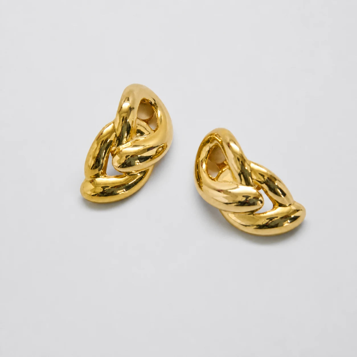 Vintage gold-tone sculptural knot clip-on earrings — front