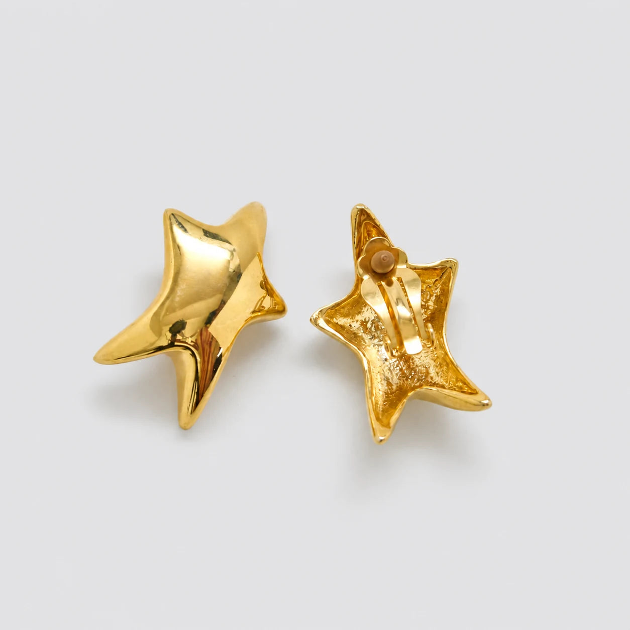 Vintage gold-tone sculptural star clip-on earrings — clip-back detail