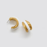Vintage gold-tone white enamel hoop earrings — angled view