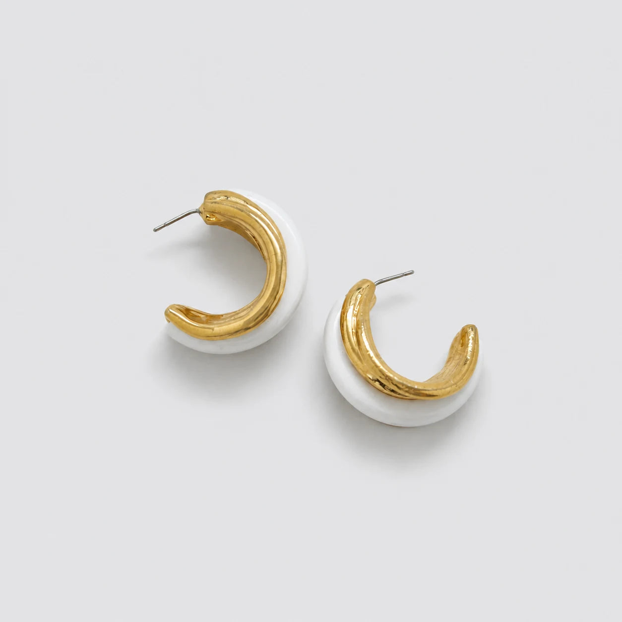 Vintage gold-tone white enamel hoop earrings — open post-back view