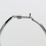 Close-up of the vintage Monet silver-tone fringe collar necklace clasp on a light gray background