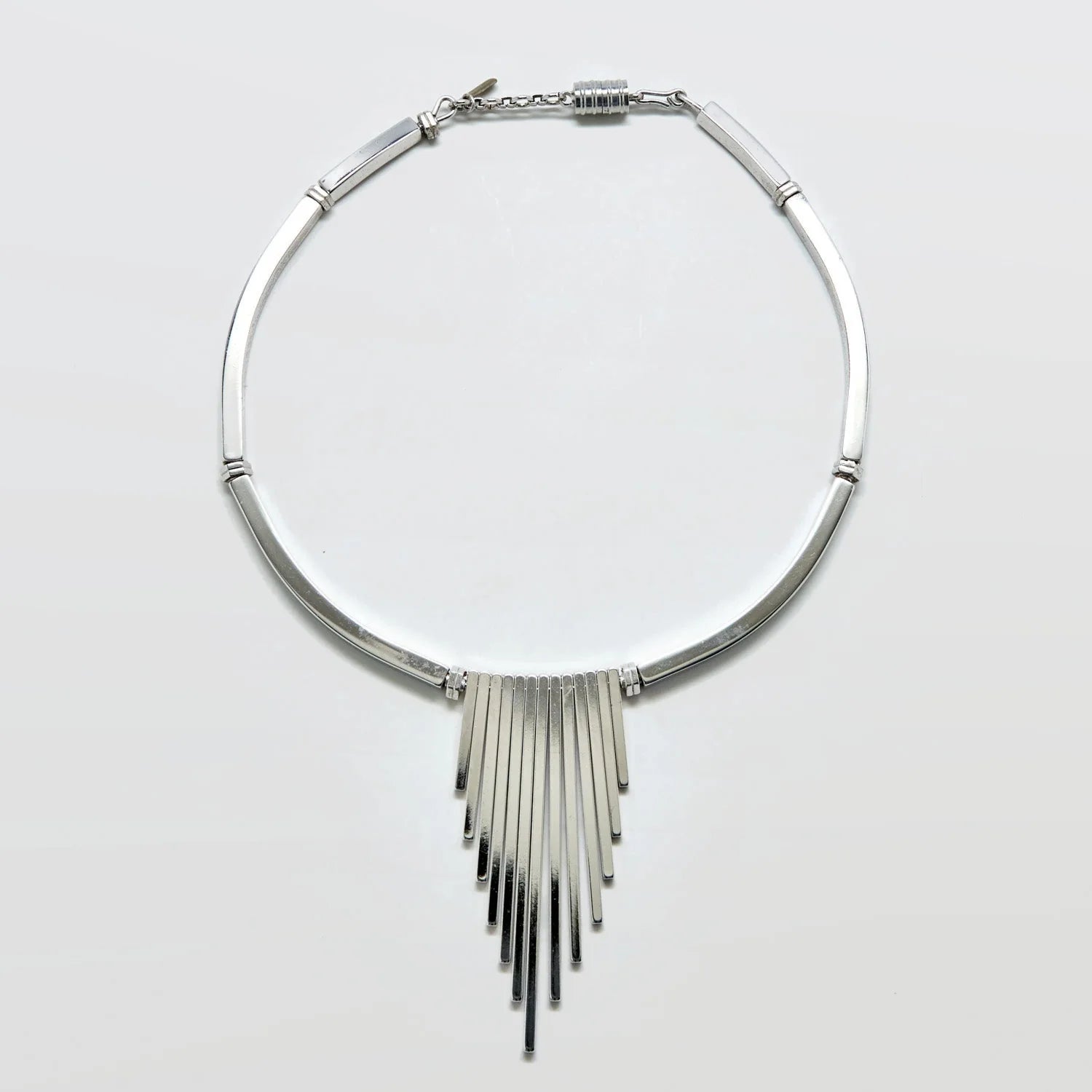 Vintage Monet silver-tone fringe collar necklace on a light gray background